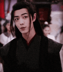 a young man with long black hair is wearing a black kimono
