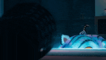 a person looking at a cartoon cat with big yellow eyes
