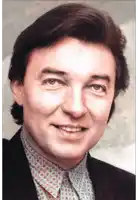a close up of a man 's face with a suit and tie