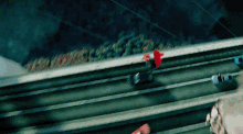 an aerial view of cars driving down a highway with trees in the background