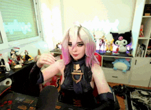 a woman with pink hair is sitting at a desk in front of a microphone with a sticker on it that says nintendo