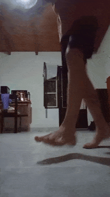a person 's feet are shown in a blurry photo in a living room