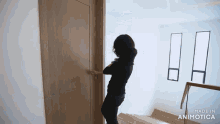 a woman is opening a wooden door made in animotica