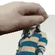 a person is holding a picture of a woman in a striped shirt .