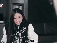 a girl is smiling in front of a sign that says on