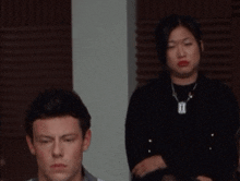 a man and a woman are sitting in a room