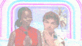 a man and a woman are standing next to each other in front of a rainbow