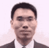 a man in a suit and tie is making a face .