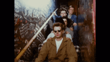 a group of young men are posing for a picture in front of a wall that says i 'm cool