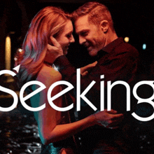 a man and a woman are hugging and the word seeking is on the bottom