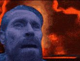a statue of a man with a beard is in front of a fire