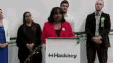 a group of people are standing around a podium that says hackney on it