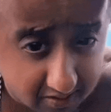a close up of a child 's face making a face .