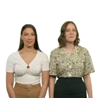 two women standing next to each other wearing different shirts
