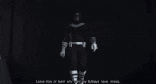 a man in a superhero costume is holding playing cards and says leave now or son
