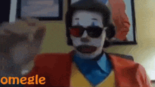 a man dressed as a clown wearing sunglasses and headphones is talking on omegle