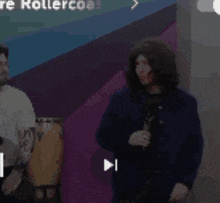 a man wearing a wig and a blue jacket is standing in front of a mirror .