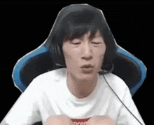 a man wearing headphones is sitting in a chair .