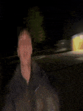 a blurry picture of a man 's face in the dark .
