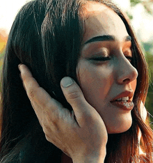 a close up of a person touching a woman 's face .