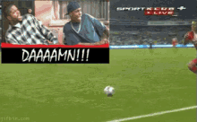 a soccer player is kicking a soccer ball in front of a banner that says daaaamn !!!