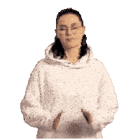a woman wearing glasses and a white hoodie is praying with her hands together