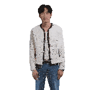a man wearing a white jacket and blue jeans stands in front of a white background