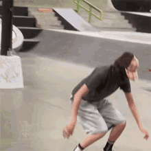 a skateboarder is doing a trick on a ramp with stairs in the background