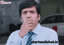 a man in a striped shirt and tie is thinking with the words starttamilchat.in above him