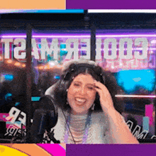 a woman wearing headphones is sitting in front of a microphone in front of a sign that says team 100s