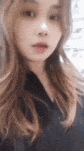 a close up of a woman 's face with her mouth open and long hair .