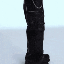 a pair of black leather cargo pants with chains on the side