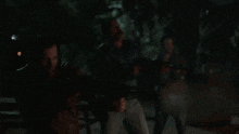 a man is holding a gun in a dark room