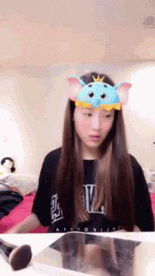 a girl wearing a mask that looks like a mouse with a crown on it