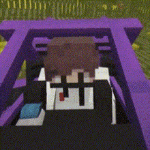 a person is sitting in a purple car with a cross on their head .