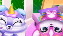 a purple unicorn and a pink cat are sitting next to each other on a bed .