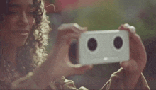 a woman is taking a picture of herself with a white phone