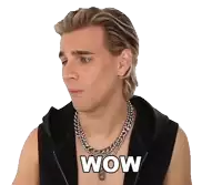 a man wearing a necklace and a black vest with the word wow on his chest
