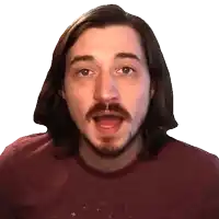 a man with long hair and a beard wearing a maroon shirt