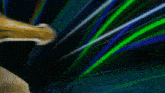 a close up of a gold object with a blue and green background