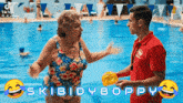 an older woman in a bathing suit talks to a lifeguard in a pool