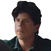 a man in a green shirt is making a funny face