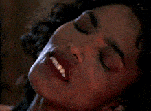 a close up of a woman 's face with a smile