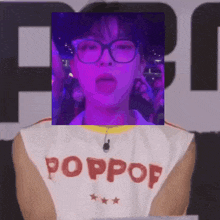 a person wearing glasses and a shirt that says poppop sticking their tongue out