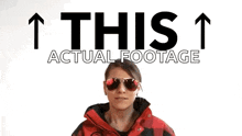 a woman wearing sunglasses stands in front of a sign that says " this "