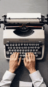 a person is typing on an old fashioned typewriter that says ' smith corona ' on it