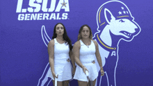 two female tennis players stand in front of a lsu generals logo