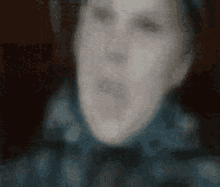 a blurry image of a person 's face with their mouth open