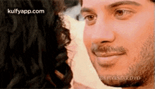 a man and a woman are looking into each other 's eyes .