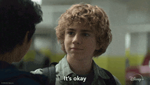 a boy with curly hair says it 's okay while talking to another boy